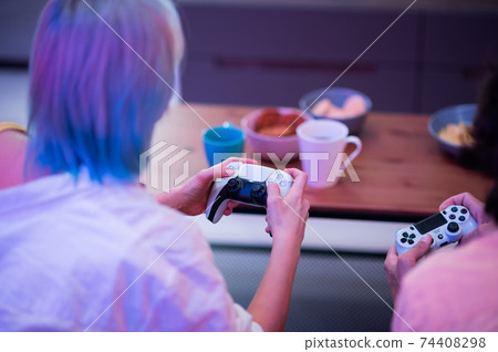 Portrait of emotional young couple playing video game at home. Portrait of emotional young couple playing video game at home. 74408298