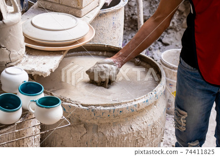 Barrel filled with mix for the clay injection molding technique in a traditional ceramics factory at the small city of Raquira in Colombia 74411825