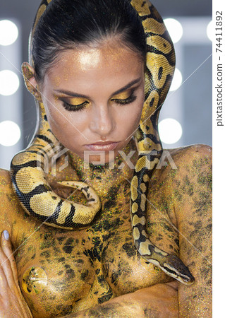 Sensual woman with snake on neck 74411892