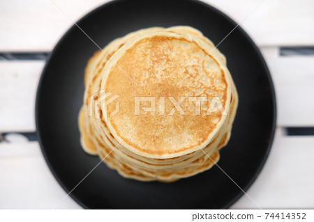 stack of classic american pancakes on a wooden rack. stack of classic american pancakes on a wooden rack. 74414352
