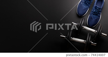 Sneakers and dumbbells. Sport, fitness and healthy lifestyle 74414807