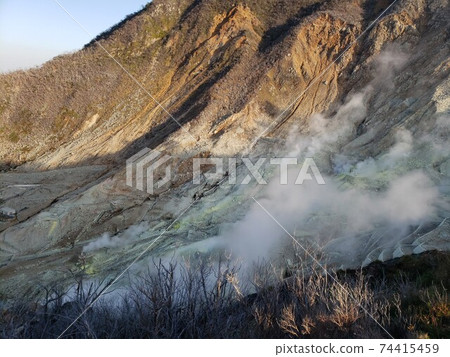 It is Owakudani in winter. In the cold air, the rising smoke looks beautiful and clear. It is a power spot and sightseeing spot. It is Owakudani in winter. In the cold air, the rising smoke looks beautiful and clear. It is a power spot and sightseeing spot. 74415459