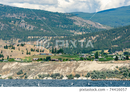 Beautiful view over Okanagan lake with mountains and clouds on background Beautiful view over Okanagan lake with mountains and clouds on background 74416057