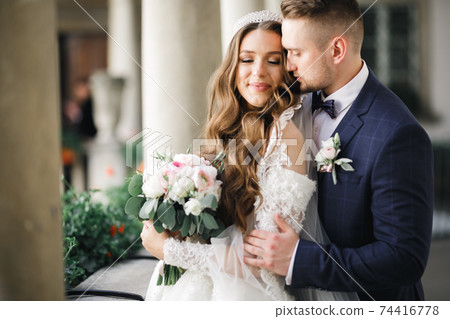Romantic wedding moment, couple of newlyweds smiling portrait, bride and groom hugging Romantic wedding moment, couple of newlyweds smiling portrait, bride and groom hugging 74416778