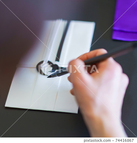 Writing with a brush pen [Funeral image] 74416867