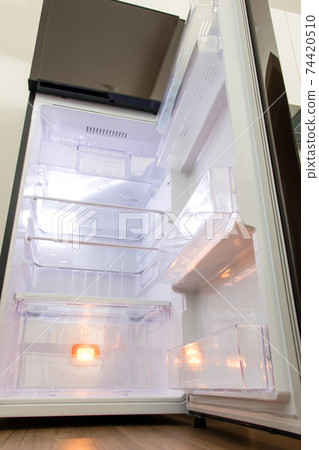 A open fridge in the kitchen. Empty clean refrigerator. 74420510