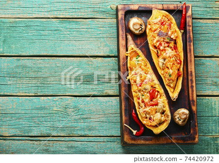 Roasted sweet potato stuffed with vegetables 74420972