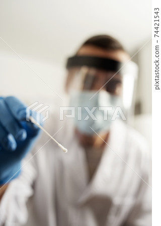 health worker taking a nasopharyngeal culture health worker taking a nasopharyngeal culture 74421543