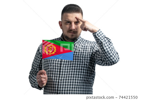 White guy holding a flag of Eritrea and a finger touches the temple on the head isolated on a white background White guy holding a flag of Eritrea and a finger touches the temple on the head isolated on a white background 74421550