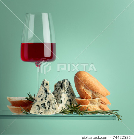 Blue cheese with bread, red wine and rosemary. 74422525