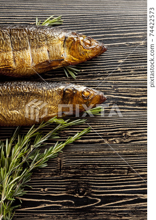 Smocked herring on an old wooden table. Smocked herring on an old wooden table. 74422573