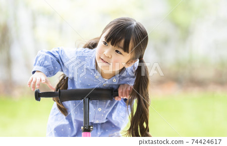 Girl riding a strider 74424617
