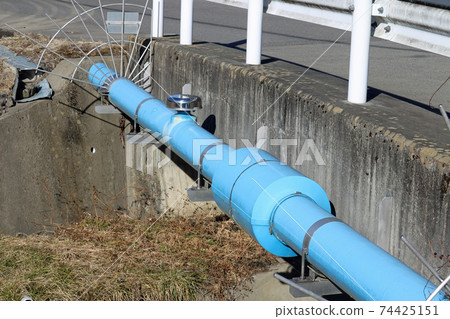 Scenery with a sewer pipe passing by the bridge Scenery with a sewer pipe passing by the bridge 74425151