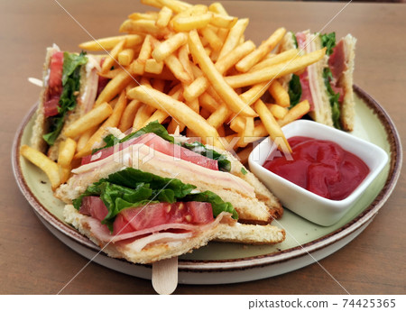 Club sandwiches and french fries Club sandwiches and french fries 74425365