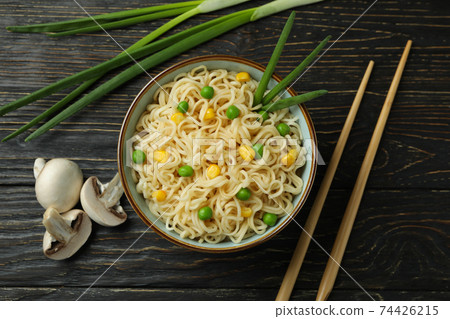 Plate with noodles, ingredients and chopsticks on wooden background Plate with noodles, ingredients and chopsticks on wooden background 74426215