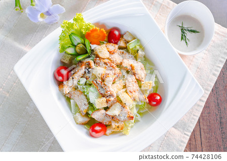 caesar salad on table. caesar salad on table. 74428106