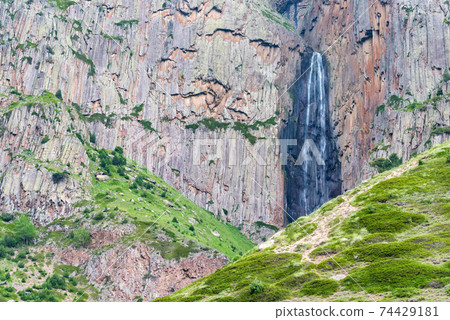 Summer landscape with mountain waterfall between two rocks Summer landscape with mountain waterfall between two rocks 74429181