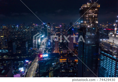 Close up aerial view of high rise skyscraper under construction in modern city center at night Tall skyscrapers in downtown Jakarta, Indonesia 74429430