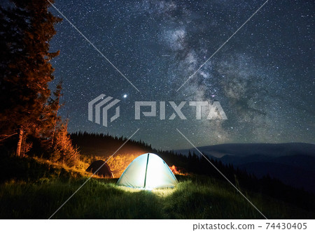 Night camping under mountain starry sky. 74430405