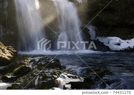 Winter waterfall shining in the morning sun Winter waterfall shining in the morning sun 74431178