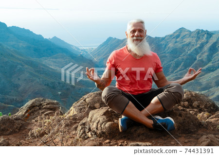 Senior man greeting sunset 74431391