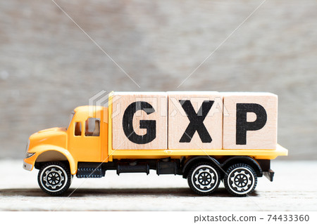 Truck hold letter block in word GXP on wood background 74433360