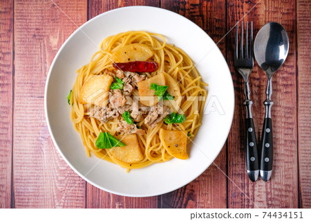 Japanese-style pasta, soy sauce flavored wood grain table, fork, spoon 74434151