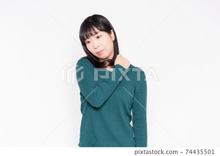 A woman suffering from stiff shoulders 74435501