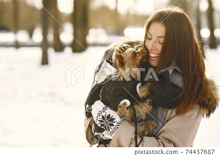 young woman hugging her dog close up outdoors young woman hugging her dog close up outdoors 74437687