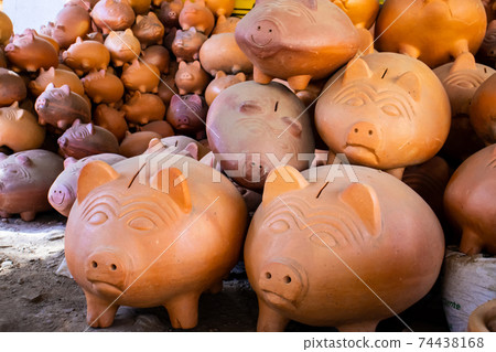 Clay piggy banks at a traditional ceramics factory in the beautiful small town of Raquira in Colombia. City of Pots 74438168