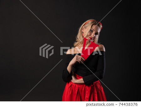 A girl holds the letters of the word LOVE love, a Valentine's board, on the floor hearts married romance. inspiration honeymoon. emotion formula of love, engagement in a red dress girl, barefoot A girl holds the letters of the word LOVE love, a Valentine's board, on the floor hearts married romance. inspiration honeymoon. emotion formula of love, engagement in a red dress girl, barefoot 74438376