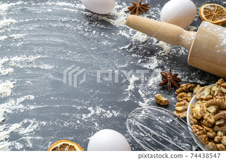 Bakery sweets. Fresh food ingredients: flour, eggs, nut and star anise, orange on black chalkboard background for bread. Spring cooking theme. Top view, copy space. Bakery sweets. Fresh food ingredients: flour, eggs, nut and star anise, orange on black chalkboard background for bread. Spring cooking theme. Top view, copy space. 74438547