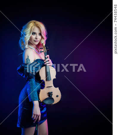 portrait of a blonde woman playing a violin in neon light portrait of a blonde woman playing a violin in neon light 74438548