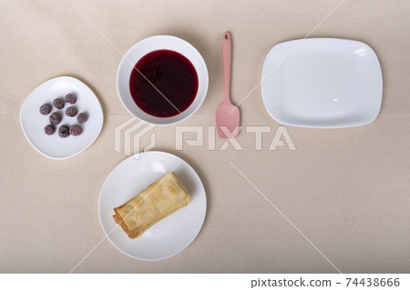 Cakes, berries and fruit jam on saucers. Ingredients for fruit cake. Cakes, berries and fruit jam on saucers. Ingredients for fruit cake. 74438666