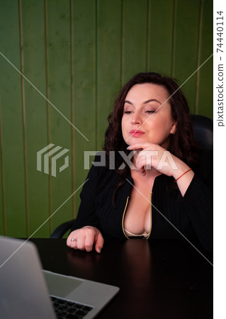 A woman with a neckline communicates in a video chat with a man and flirts 74440114