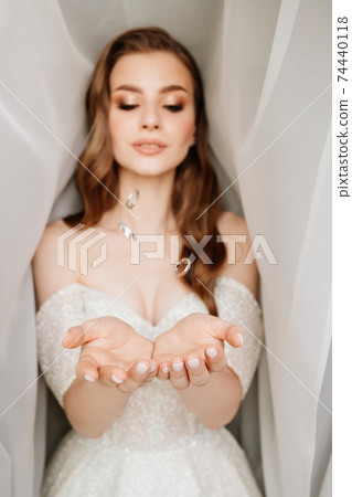 wedding rings are tossed and fall into hands of the bride. exchange of rings wedding rings are tossed and fall into hands of the bride. exchange of rings 74440118