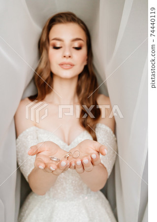 wedding rings are tossed and fall into hands of the bride. exchange of rings wedding rings are tossed and fall into hands of the bride. exchange of rings 74440119