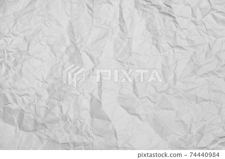 a crumpled white sheet of paper on a black background. a crumpled white sheet of paper on a black background. 74440984
