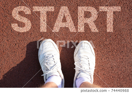 men's feet in white socks and sneakers on a sports treadmill. that says start. men's feet in white socks and sneakers on a sports treadmill. that says start. 74440988