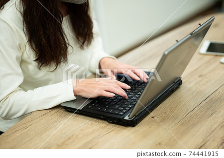 Middle woman using a personal computer Middle woman using a personal computer 74441915