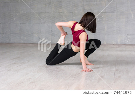 Woman dancer doing stretching exercise. Woman dancer doing stretching exercise. 74441975