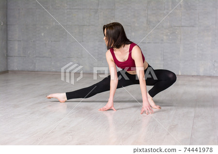 Young woman stretching on studio background. Young woman stretching on studio background. 74441978