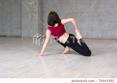 Slim woman practicing gymnastic element. 74441982