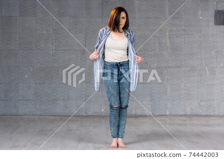 Young beautiful girl posing on studio background. Young beautiful girl posing on studio background. 74442003