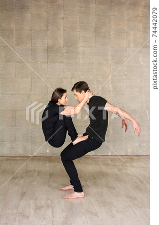 Couple of dancers practicing acrobatics element. Couple of dancers practicing acrobatics element. 74442079