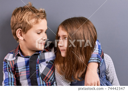 Couple of kids looking at each other. Couple of kids looking at each other. 74442347