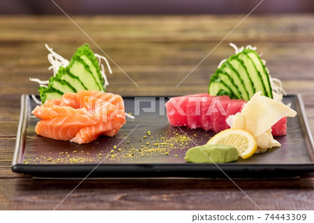 Sliced red and orange fish fillet and side dish. Sliced red and orange fish fillet and side dish. 74443309