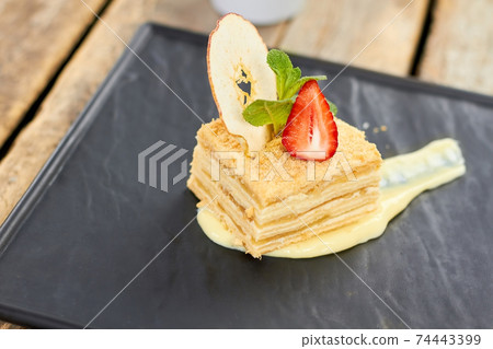 Napoleon cake decorated with straberry, apple and mint. Napoleon cake decorated with straberry, apple and mint. 74443399