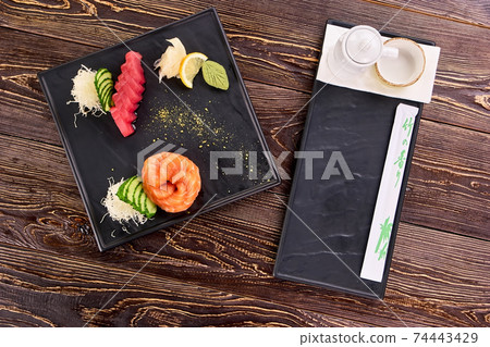 Appetizing fresh juisy sushi on square black plate. Appetizing fresh juisy sushi on square black plate. 74443429