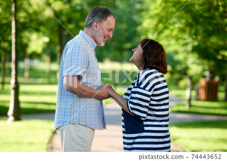 Smiling caucasian couple looking at each other. Smiling caucasian couple looking at each other. 74443652